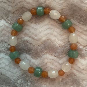 Green white and light brown stretch bead bracelet.
